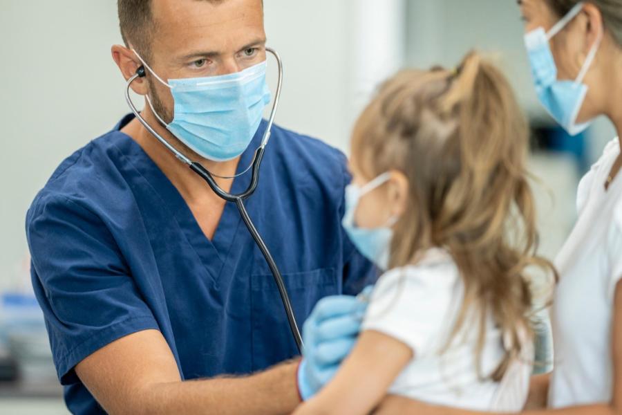 Picture of a medical provider examining a child 